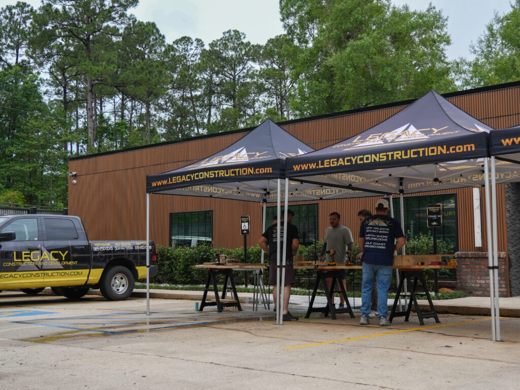 Impact Day 2026: Building More Than Beds 8 Legacy Construction and Development volunteers working together to build beds at the 2026 Legacy Day community service event in Louisiana