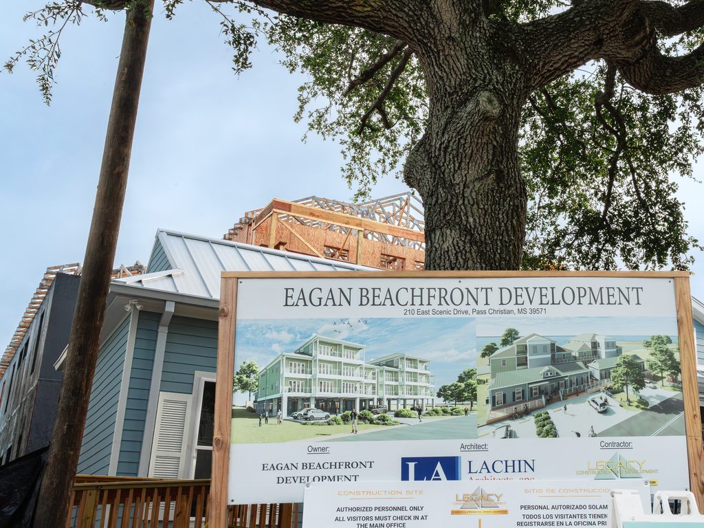 Eagan Beachfront Development sign showing architectural renderings and Legacy Construction & Development as the contractor.